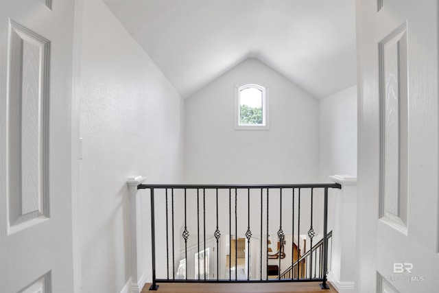 stairs featuring baseboards and lofted ceiling