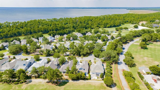 birds eye view of property featuring a view of trees, a residential view, and a water view