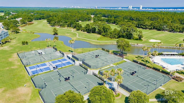 bird's eye view featuring a water view, a view of trees, and view of golf course