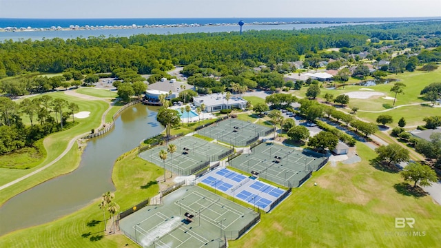 bird's eye view featuring a water view, a wooded view, and view of golf course