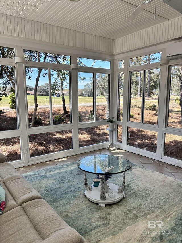 sunroom / solarium featuring an AC wall unit