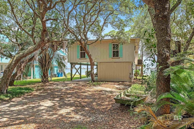 14752 State Highway 180, Gulf Shores, AL 36542 - back of house featuring a carport and dirt driveway