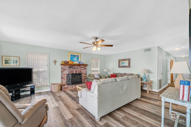 14752 State Highway 180, Gulf Shores, AL 36542 - living room with a ceiling fan, wood finished floors, and a fireplace