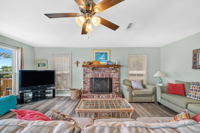 14752 State Highway 180, Gulf Shores, AL 36542 - living room with wood finished floors, ceiling fan, and a brick fireplace