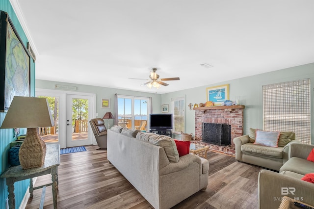 14752 State Highway 180, Gulf Shores, AL 36542 - living room featuring a brick fireplace, wood finished floors, and a ceiling fan