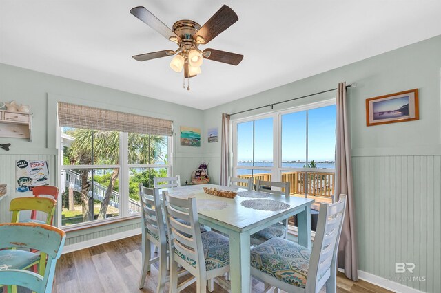14752 State Highway 180, Gulf Shores, AL 36542 - dining space with a water view, wood finished floors, plenty of natural light, and a wainscoted wall