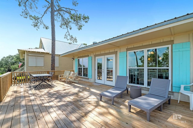 14752 State Highway 180, Gulf Shores, AL 36542 - wooden terrace with french doors and outdoor dining space