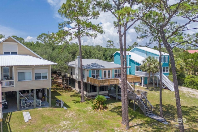 14752 State Highway 180, Gulf Shores, AL 36542 - rear view of house featuring stairway, a lawn, and a deck