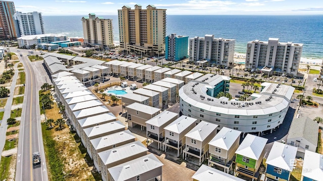 birds eye view of property featuring a water view and a view of city
