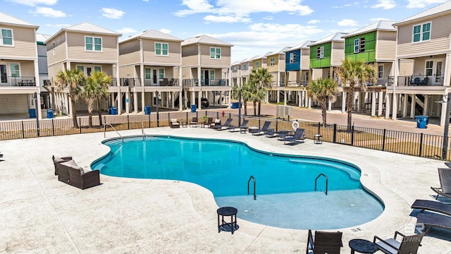 pool featuring fence, a residential view, and a patio