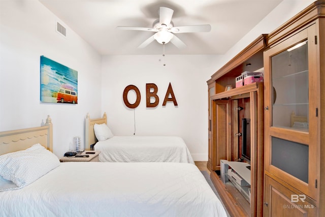 bedroom featuring ceiling fan and wood-type flooring