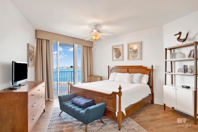 bedroom featuring access to exterior, light hardwood / wood-style floors, and ceiling fan