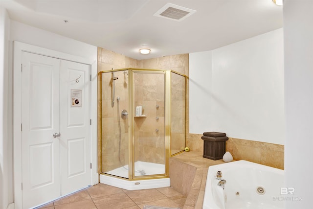 bathroom with tile patterned flooring and independent shower and bath