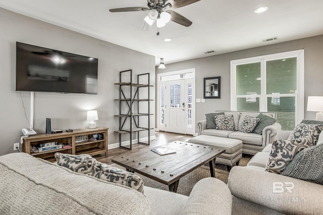 living room featuring ceiling fan and hardwood / wood-style floors