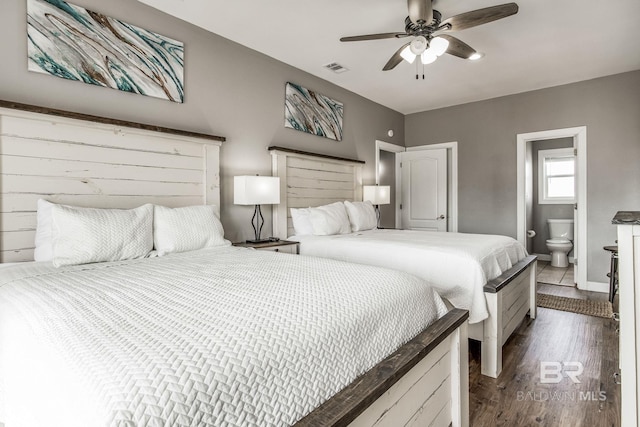 bedroom featuring dark hardwood / wood-style flooring, ceiling fan, and ensuite bathroom