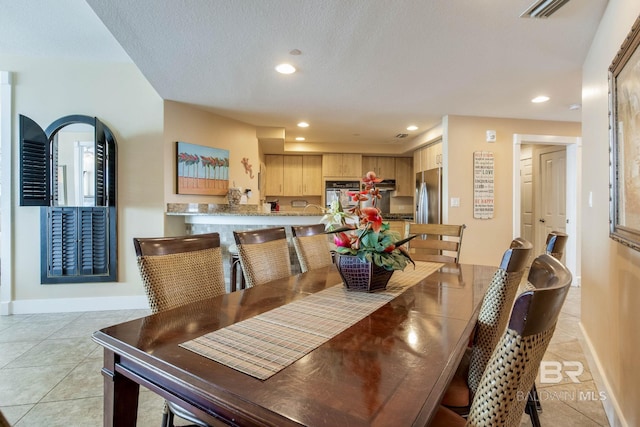 dining room featuring baseboards, light tile patterned flooring, visible vents, and recessed lighting