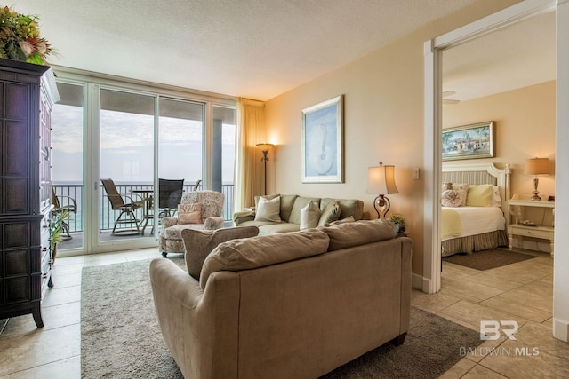 living area with a textured ceiling and light tile patterned floors