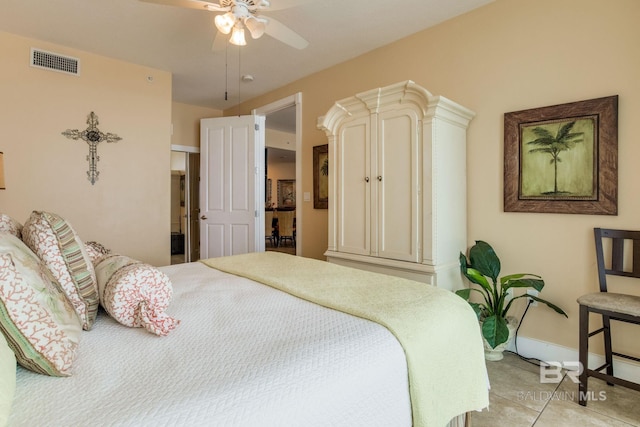 bedroom featuring visible vents, ceiling fan, baseboards, and light tile patterned floors