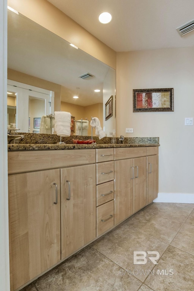 full bath with double vanity, baseboards, visible vents, and recessed lighting