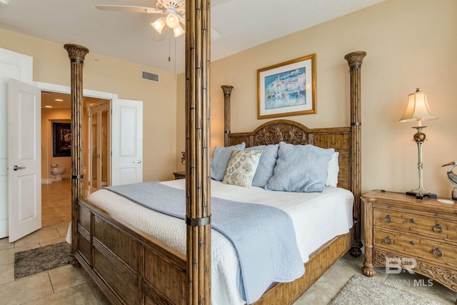 bedroom with a ceiling fan, visible vents, ensuite bath, and light tile patterned floors