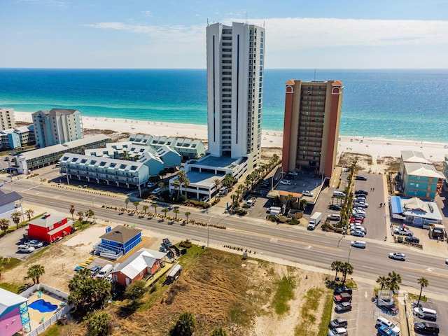 drone / aerial view featuring a water view and a beach view