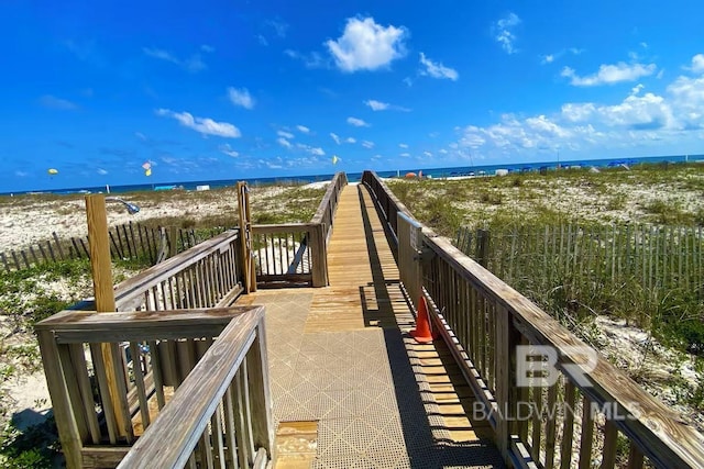 surrounding community featuring a water view and a view of the beach