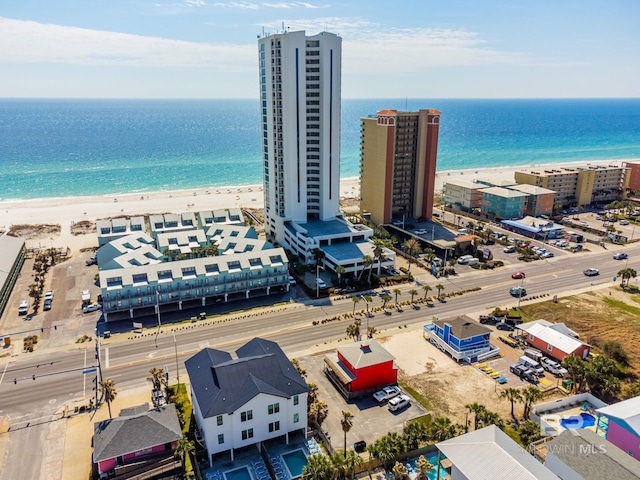 aerial view with a water view and a beach view