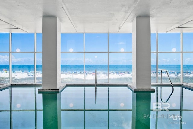 view of swimming pool with a water view and a pool