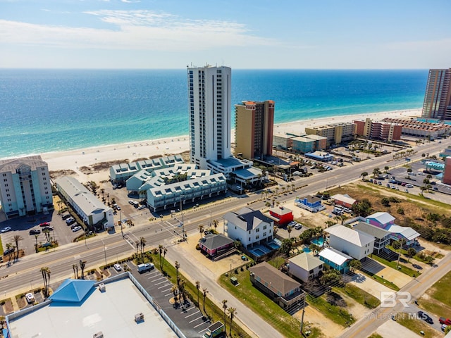 drone / aerial view with a water view and a beach view