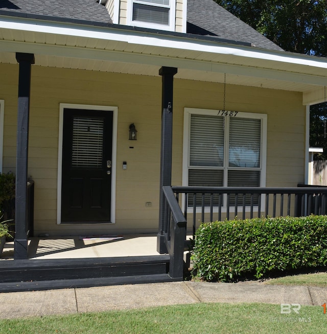 view of exterior entry featuring a porch