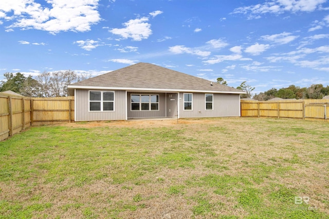 back of house with a lawn