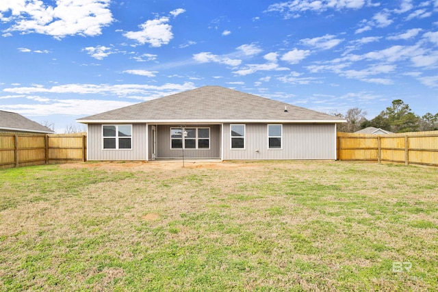 rear view of house with a yard