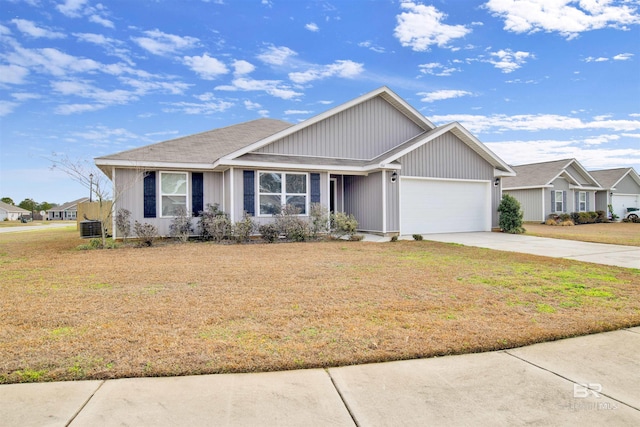 view of front of house featuring a garage and a front lawn