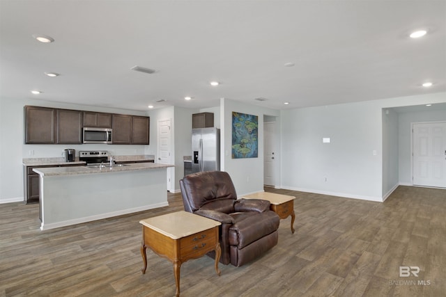 living room featuring hardwood / wood-style floors and sink