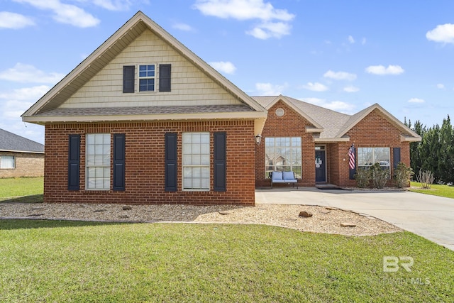 view of front of property with driveway, brick siding, a front lawn, and a shingled roof