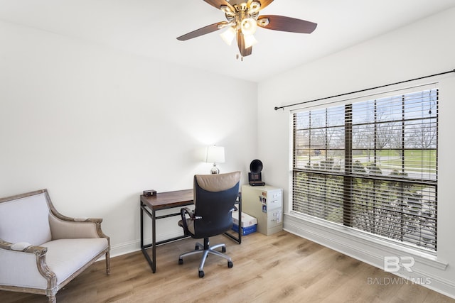 office with a ceiling fan, wood finished floors, and baseboards