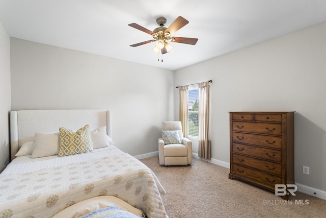 bedroom with light colored carpet, a ceiling fan, and baseboards