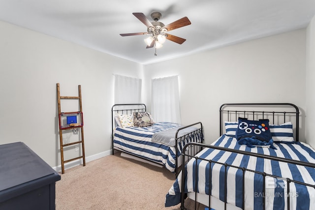 carpeted bedroom featuring baseboards and ceiling fan