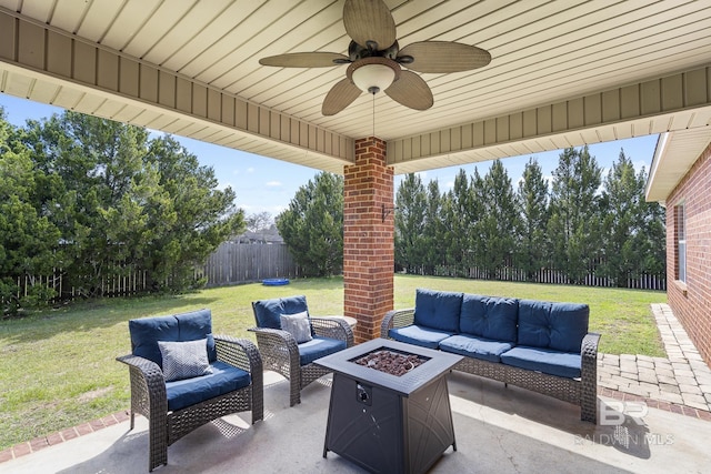 view of patio / terrace with an outdoor living space with a fire pit, a fenced backyard, and a ceiling fan