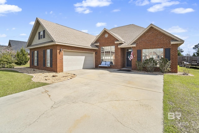 traditional home with brick siding, an attached garage, a shingled roof, a front yard, and driveway