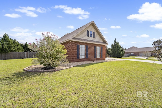 view of front of property featuring brick siding, a front yard, and fence