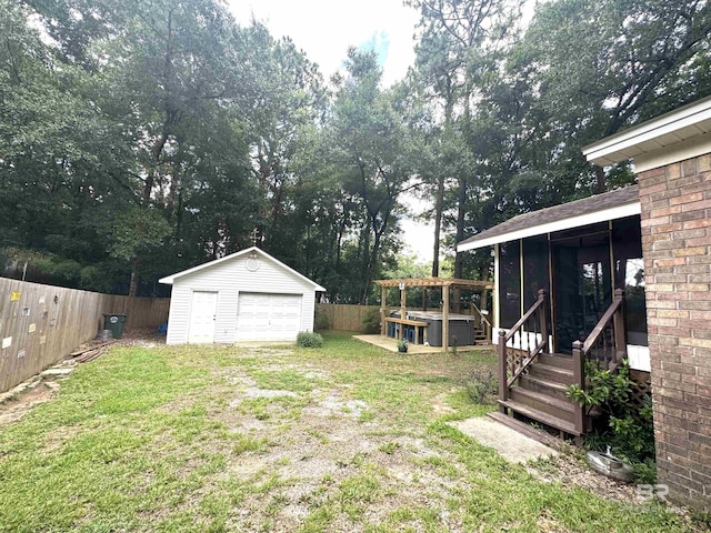 513 3rd St, Fairhope, AL 36532 - fenced backyard featuring a garage, an outbuilding, a sunroom, and view of wooded area