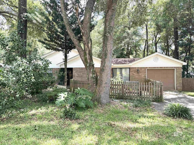 513 3rd St, Fairhope, AL 36532 - ranch-style house featuring brick siding, an attached garage, and concrete driveway