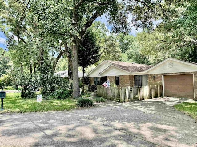 513 3rd St, Fairhope, AL 36532 - single story home with an attached garage, driveway, and brick siding