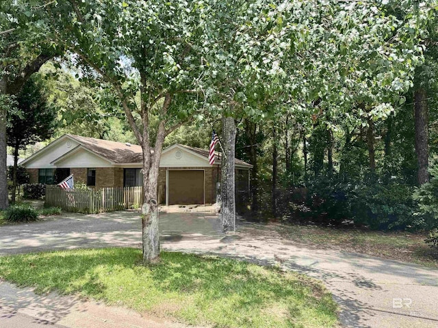 513 3rd St, Fairhope, AL 36532 - view of front of property with driveway, an attached garage, and brick siding