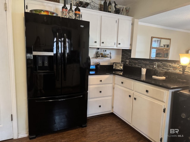 513 3rd St, Fairhope, AL 36532 - kitchen featuring black fridge, crown molding, white cabinetry, backsplash, and dark wood-type flooring