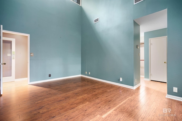 6 Pirates Ln, Spanish Fort, AL 36527 - unfurnished room featuring a towering ceiling and wood finished floors