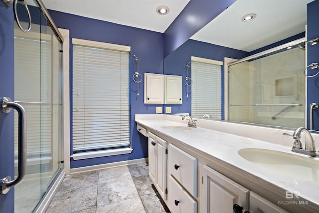 6 Pirates Ln, Spanish Fort, AL 36527 - bathroom featuring double vanity, a shower with shower door, stone finish flooring, and recessed lighting