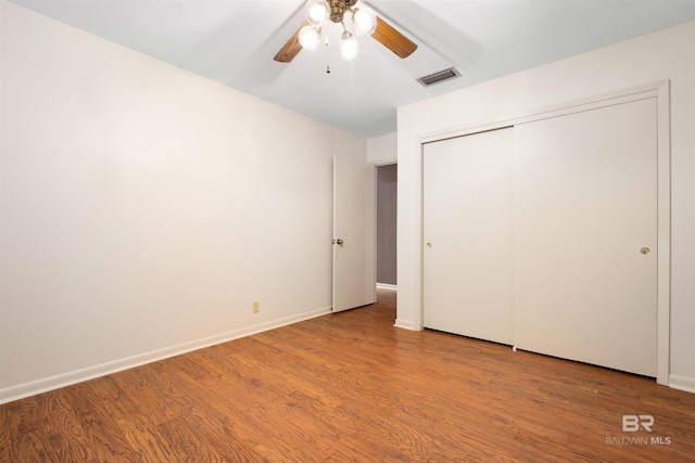 6 Pirates Ln, Spanish Fort, AL 36527 - unfurnished bedroom with wood finished floors, a closet, and a ceiling fan