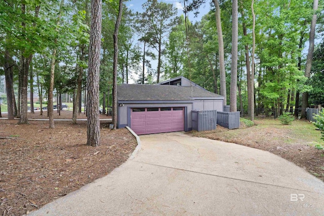 6 Pirates Ln, Spanish Fort, AL 36527 - view of side of home with concrete driveway, view of wooded area, and roof with shingles